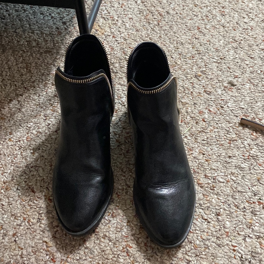 Black booties with gold zipper